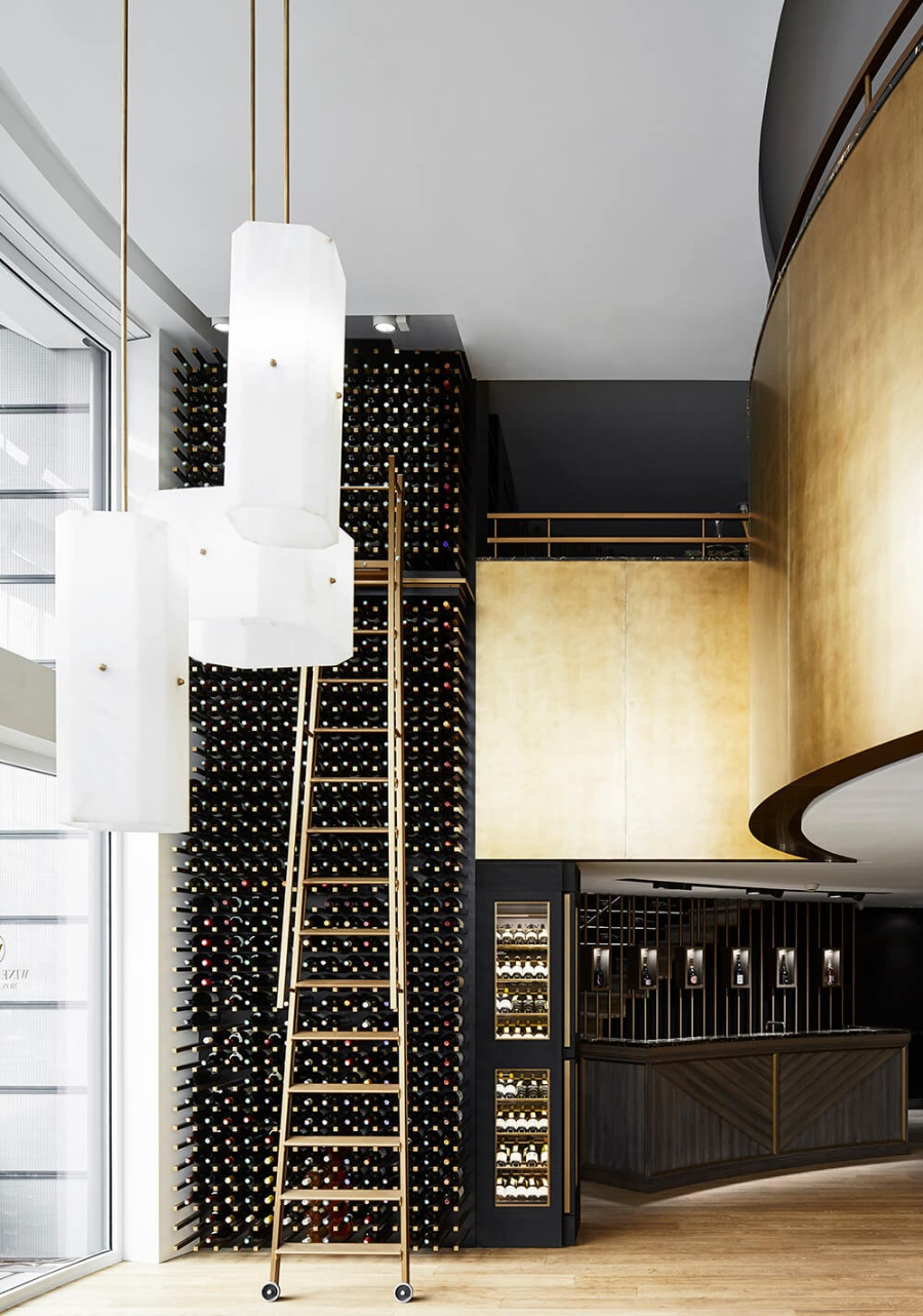 Humbert et Poyet Present Luxurious Retail Projects. Wine Palace with dark tones and golden details